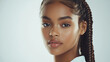 © Infinity Lens - Confident african woman with braided hair and perfect skin, studio shot on white background, cosmetics advertise concept.