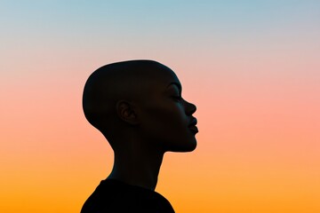 Fototapete - Silhouette of a person with a smooth bald head against a colorful sunset sky creating a serene and contemplative atmosphere. Generative AI