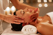 © Home-stock - Young woman lying on spa bed receiving facial massage from professional therapist, lady enjoying body treatments in tranquil atmosphere
