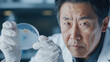 © Sergey - Scientist analyzing petri dish in laboratory - asian researcher focused on microbiology experiment