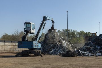 Wall Mural - Large excavators work on scrap metal