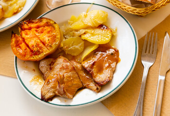 Wall Mural - Appetizing pork in sauce with baked potatoes and grilled tomato