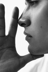 Black and white casual headshot of handsome young man posing over white background. Mindset concept.