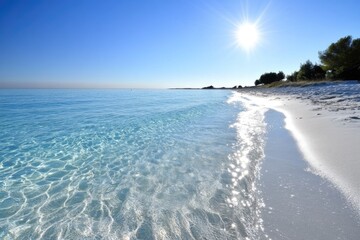 tranquil sandy beach with clear blue waters under a bright sun