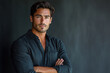 © Midea  - Man with crossed arms against black background exuding confidence and determination.