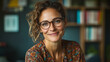 © Mykhailo Shvets - Warm and Friendly Caucasian Female Teacher Smiling in a Cozy Classroom or Library, Wearing Glasses and a Colorful Blouse, Creating an Engaging and Supportive Educational Atmosphere