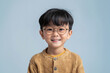 © Surachetsh - Young Asian boys in relaxed, casual clothing stand against a plain white background, showcasing their joyful innocence and individual styles.