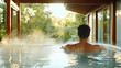© siraphol - Soaking in tranquil onsen with steam rising, surrounded by nature beauty