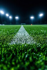 Nighttime football field with illuminated goalposts and vibrant green grass, ready for play