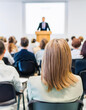 © lina - attentive audience listening to a speaker during a business conference