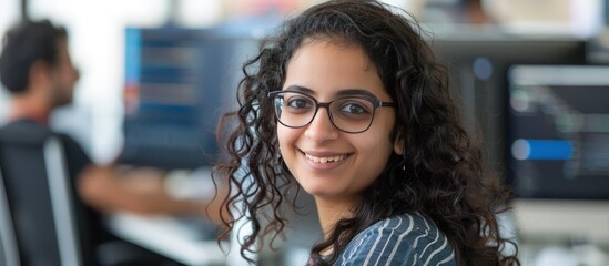 Young female Indian IT developer programmer working with laptop in the office. AI generated image