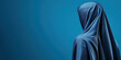 © Vasiliy - Woman in blue silk hijab on blue background. Religious clothing and modest fashion