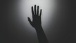 © Soemsuk - Black and White Silhouette of a Hand Reaching Out Against a Soft Gray Background