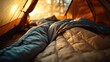 © LiaSyafitri - Cozy camping scene inside a tent with sleeping bags, warm sunlight filtering through trees outside