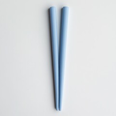 Canvas Print - Light blue chopsticks on white background