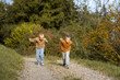 © Анна Зеленая - Two boys run to race on a dirt road in the forest. Siblings connection