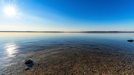 Wall Mural - calm waters at sunrise tranquil lake nature scene clear sky wide angle peaceful reflection