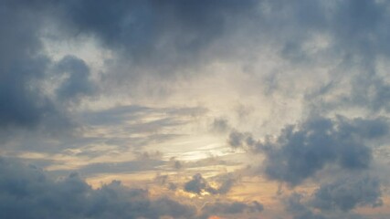 Wall Mural - movement of beautiful low clouds in the blue sunset sky; time lapse video.