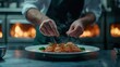 © kwangze - A chef garnishes a gourmet dish of scallops, presenting it elegantly in a kitchen with flames in the background, showcasing culinary artistry.