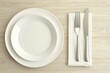 © Suriya - Minimalist Table Setting with Nested Plates and Silverware
