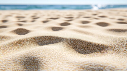 Aufkleber - Fine sandy beach background under bright sunlight with gentle waves in the distance and a clear blue sky