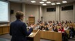 © IbragimovN - Speaker addressing audience in modern lecture hall with professional presentation setting