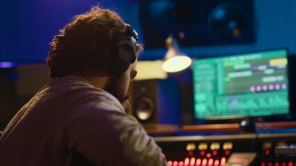 Fototapete - Talented guitarist doing live performance in professional studio, recording new tracks on mixing console amplifier. Young artist musician performing new songs, create music. Camera A.