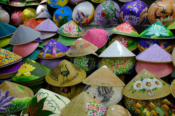 Wall Mural - Paddy hats or conical straw hats for sale at a market stall in Dong Ba market. The conical hat is a great symbol of Vietnam.  Hue. Vietnam.