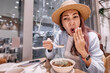 © EdNurg - Tourist enjoying traditional food in a chinese restaurant, surprised by the taste of hot and spicy soup