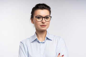 Canvas Print - Photo of pretty businesswoman wearing eyeglasses standing in the office isolated over white