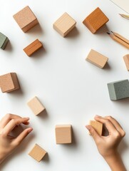 Aufkleber - Minimalist Educational Workspace Childrens Hands Engaging with Textured Wooden Blocks on White Surface - Interactive Learning Tools for Early Childhood Development and Skill Enhancement
