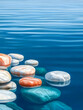Peaceful stones sit in rippling water, used for meditation, calm. Waves in the water, providing a serene background