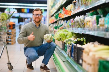 Sticker - Handsome man shopping in a supermarket