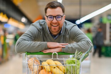 Sticker - Young man buying groceries at the supermarket. Consumerism concept