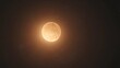 © AhmadTriwahyuutomo - A luminous golden moon surrounded by a dark sky, creating a serene and enchanting celestial scene.