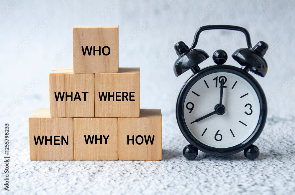 Who, What, Where, When, Why and How text on wooden cubes with table ...