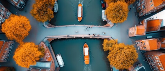 Wall Mural - Aerial shot of a historic bridge over a river with boats passing under