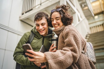 Wall Mural - couple boyfriend and girlfriend stand and use cellphone on stairs