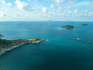 Fototapete - Aerial view A rocky promontory that juts out into the sea at Laem Promthep Cape viewpoint. Promthep cape is the most popular viewpoint in Phuket..Man island in front Promthep viewpoint..
