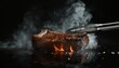 © Daria - Realistic image of t bone steak grilling with tongs, flames, and smoke on black background