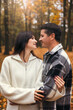 © ADDICTIVE STOCK - Couple Embracing in an Autumn Forest With Joyful Smiles