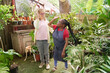 © Caia Image - Disabled women giving high five at plant nursery