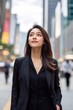 © photo of people - A mid-20s East Asian business woman with a gentle expression standing on a busy high-rise street staring into the sky.