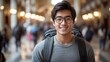 © Oleksandr - Smiling traveler with glasses in a grand hallway filled with people during a lively afternoon adventure