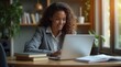 © Caspernik - Happy Black Professional Woman Working on Laptop in Home Office
