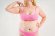 © staras - Fat woman in pink underwear on gray background, overweight female, obesity body, weight loss concept
