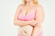 © staras - Fat woman in pink bra with large natural saggy breasts after breastfeeding on gray background, overweight female obesity body, weight loss concept