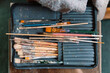 © ADDICTIVE STOCK - Collection of Used Paintbrushes in a Fabric Case on Artist’s Table