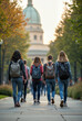 © Cadengo - The image shows a group of students walking on a sidewalk, with backpacks on, heading towards a domed building in the background
