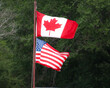 © Barbara - Canadian And American Flags Flying Proudly At The Saskatchewan International Raceway, Saskatoon Dist., Saskatchewan August 17, 2024